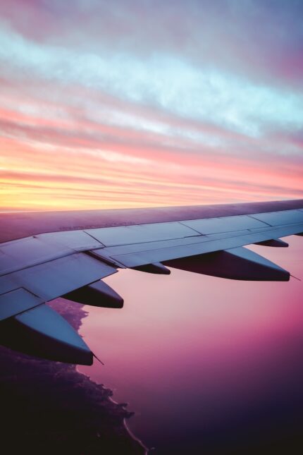 airplane wing under orange sky